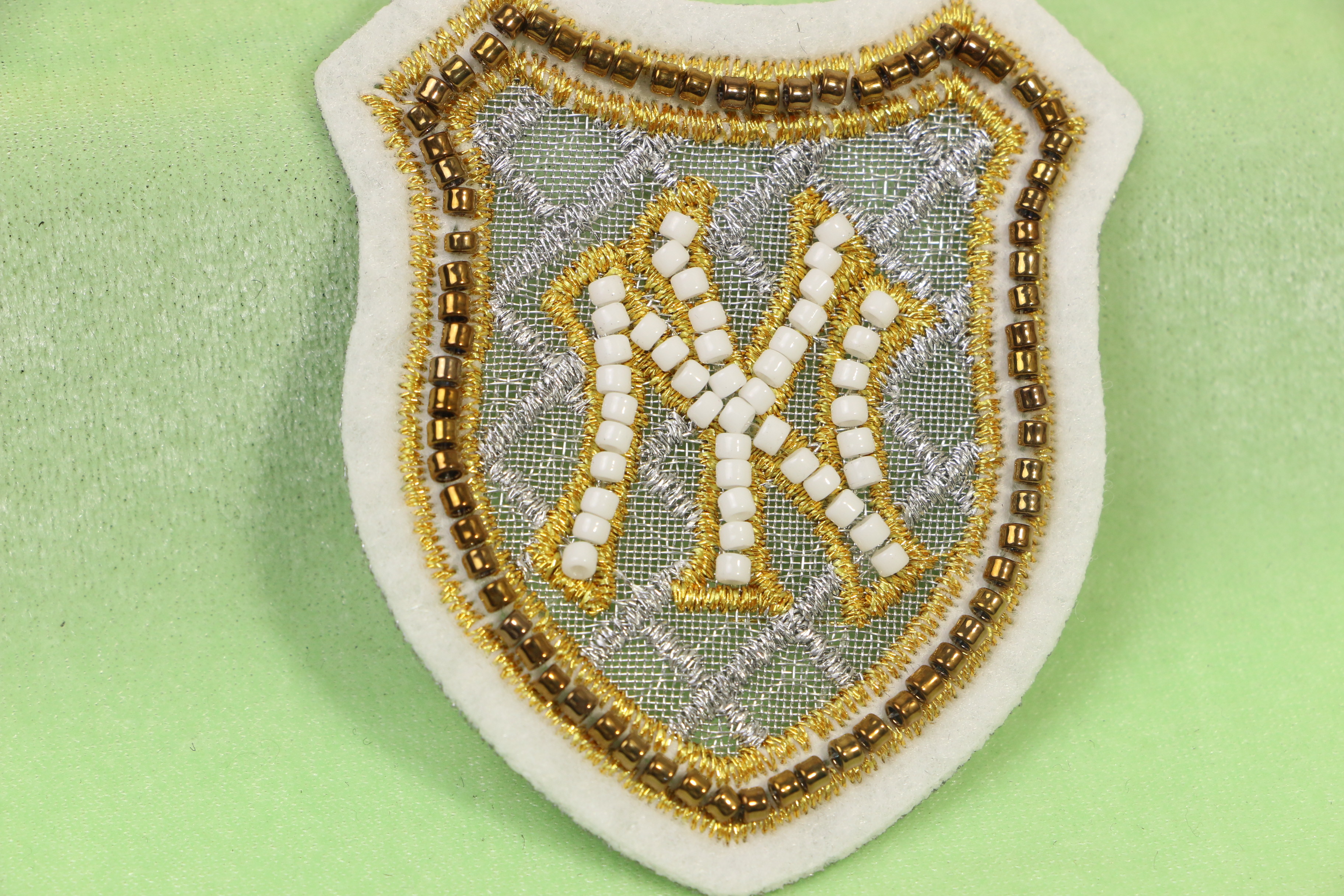 Buy cheap Stylish Silver Gold Metallic Embroidery Badge With White Felt Ground Beads from wholesalers