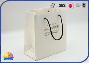 China Custom Logo Paper Shopping Bags Luxury Boutique Gift Paper Bag With Handle on sale